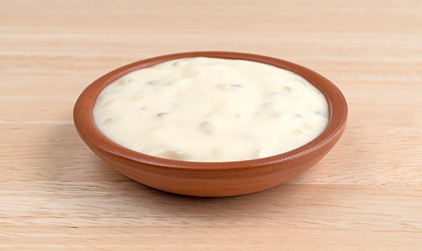 istock Small bowl of tartar sauce on a wood table 582274414