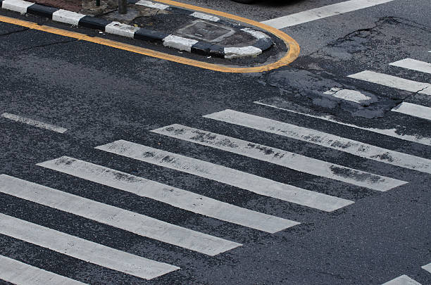 istock crossing on the road, zebra traffic walk way 582279724