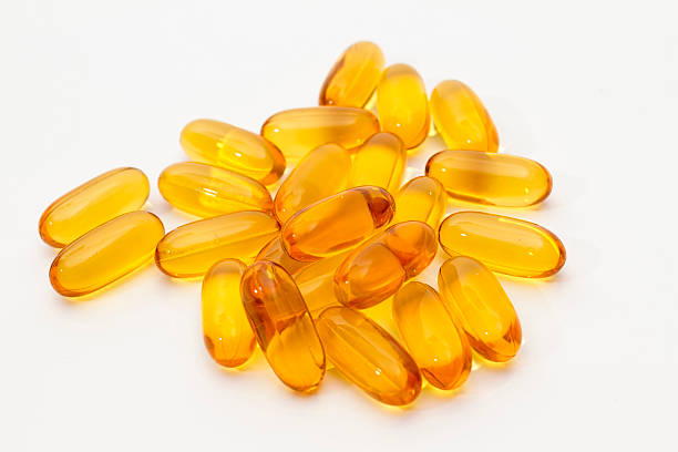 istock Omega-3 fish fat oil capsules, on a white background 582280060
