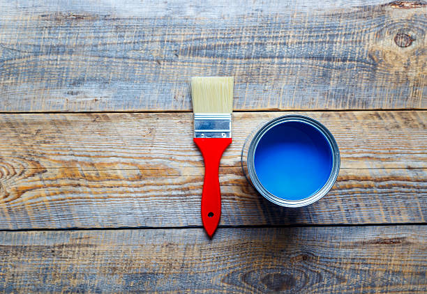 istock open paint jar and brush on wooden background top view 582280280