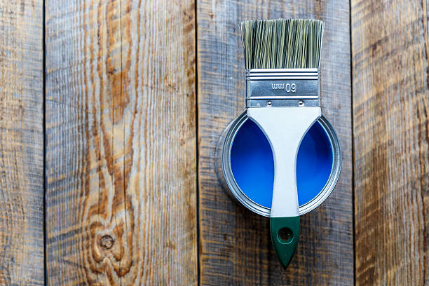 istock jar with blue paint on the wooden background top view 582280398