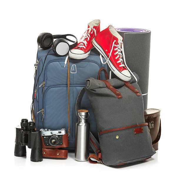 istock The suitcases, sneakers, retro camera, karrimat and binoculars on white 582281482