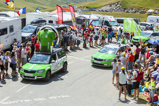 Col Du Glandon, France - July 23, 2015: Skoda caravan during the passing of the Publicity Caravan on Col du Glandon in Alps during the stage 18 of Le Tour de France 2015. Skoda is the official car of the competition and sponsors the Green Jersey.