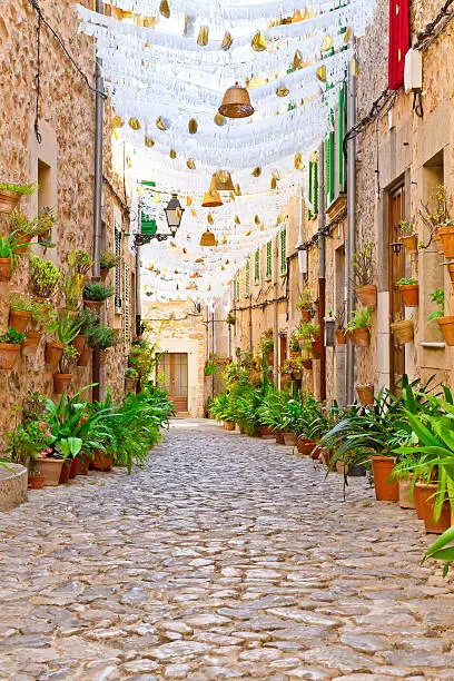 Green lane in Valldemossa with decorated houses to Assumption Day, Mallorca, Spain