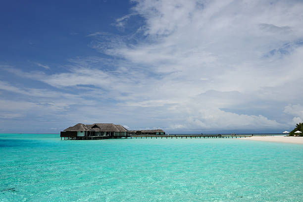 istock Beautiful beach with water bungalows 582287486