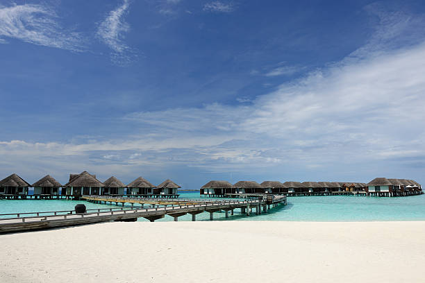 istock Beautiful beach with water bungalows 582287644