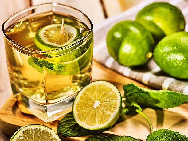 istock Glass with green transparent lime drink and mint napkin. 582288048