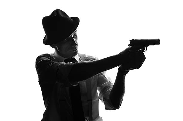 istock Silhouette of detective with two guns 582288354