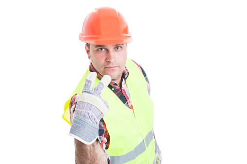 Look into my eyes or pay attention on me concept with handsome builder in work clothes isolated on white background