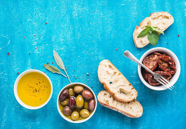 istock Mediterranean snacks set. Olives, oil, sun-dried tomatoes, herbs and 582289368