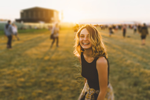 Young Caucasian girl has fun on music festival