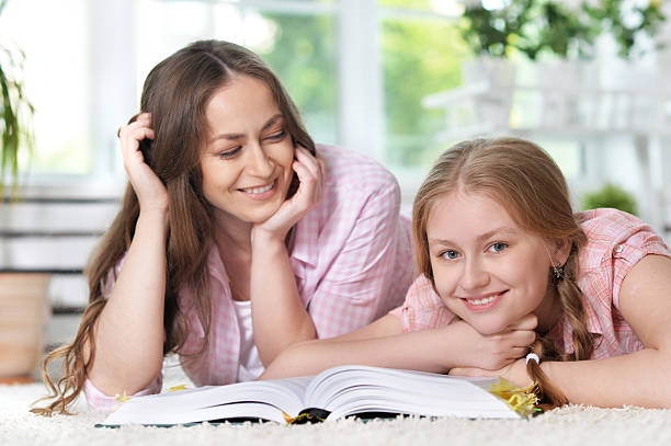 istock mother helping her  daughter with homework 582291674