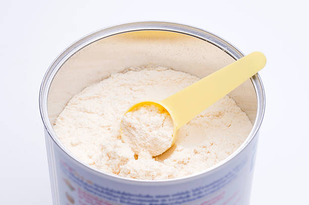 istock Baby milk powder in cans that open with a spoon 582292124