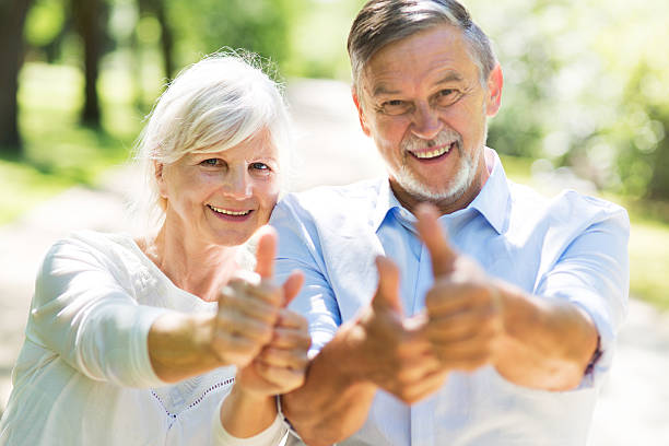 istock Senior couple showing thumbs up 582292300