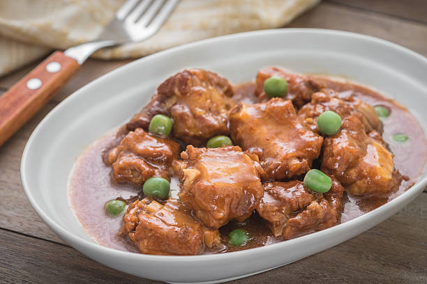 istock Braised pork ribs with green peas in bowl 582295190
