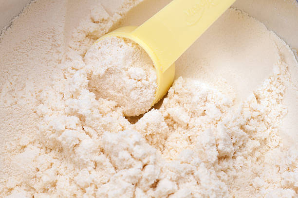 istock baby milk powder in cans that open with a spoon 582295570