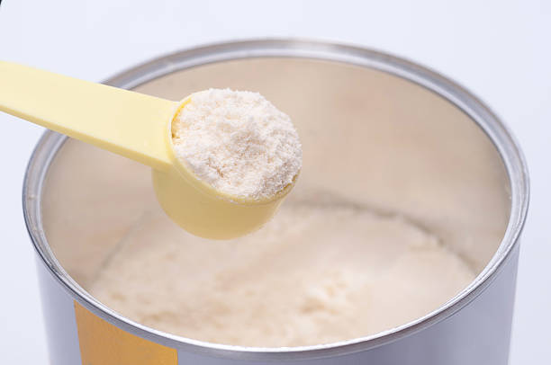 istock Baby milk powder in cans that open with a spoon. 582296022