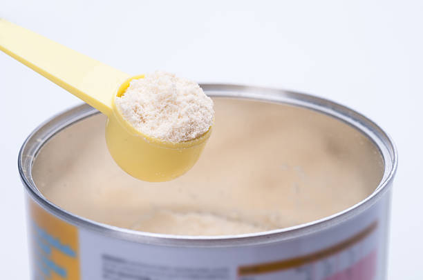 istock Baby milk powder in cans that open with a spoon. 582296190