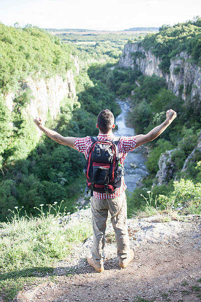 istock Young hiker standing on top of the mountain 582296268