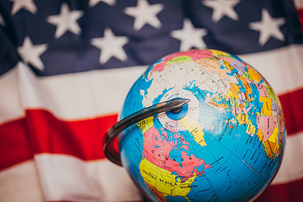 istock US flag with map of the world 582297598
