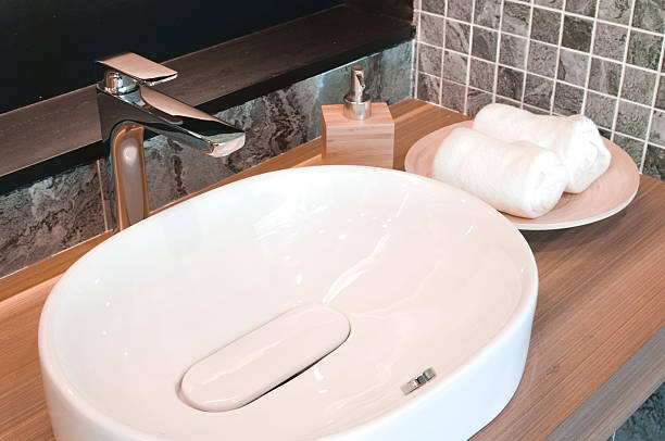 istock Faucets and sinks Ceramic White. On a wooden table top 582300556