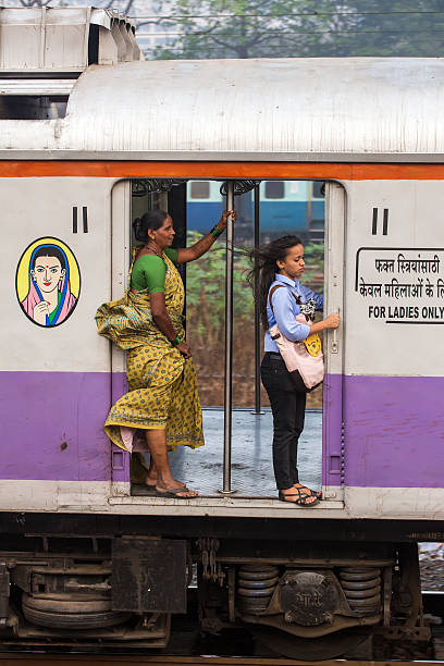 Unidentified women traveling via Suburban train in Mumbai, India. stock photo