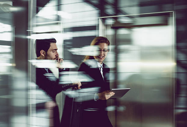 Two Business coworkers walking along elevated walkway