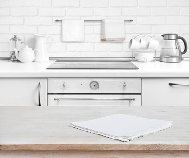 istock Wooden table with towel over defocused rustic kitchen bench background 582304556