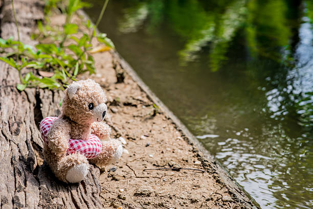 istock Teddy bear doll toy with life ring swimming 582304674