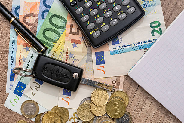 istock car key, euro banknotes, pen, coins and notebook 582304826