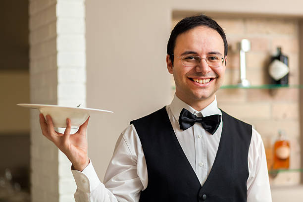 istock Smiling waiter portrait 582305076