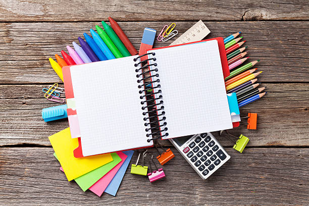istock Notepad for your text over colorful supplies on wood 582305616