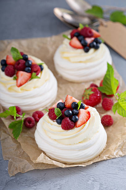 istock Pavlova cakes with cream and fresh berries 582305660