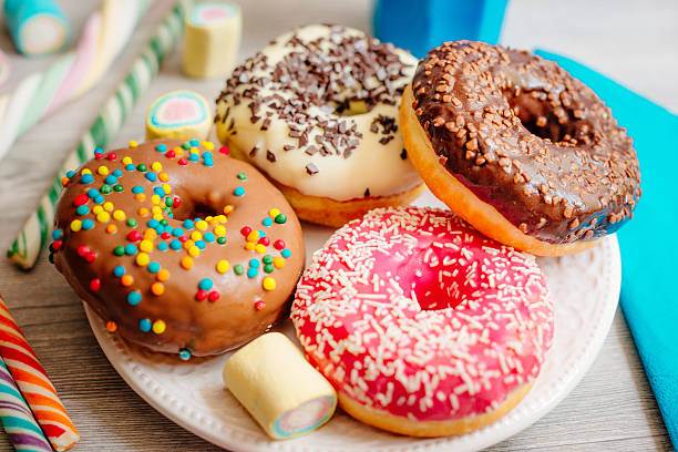 Four colours of donuts Image of multi colour glazed donuts doughnut stock pictures, royalty-free photos & images