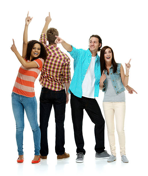 istock Smiling four friends pointing away 582308554