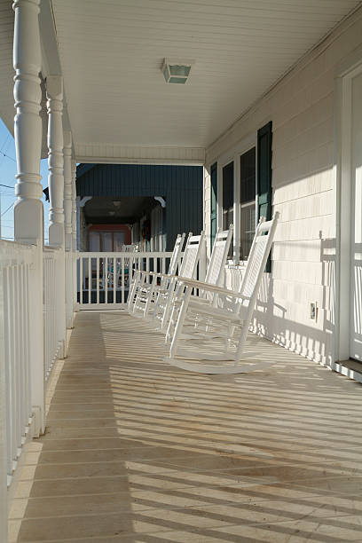 istock Four Rocking Chairs On A Porch At Sunrise 582308670
