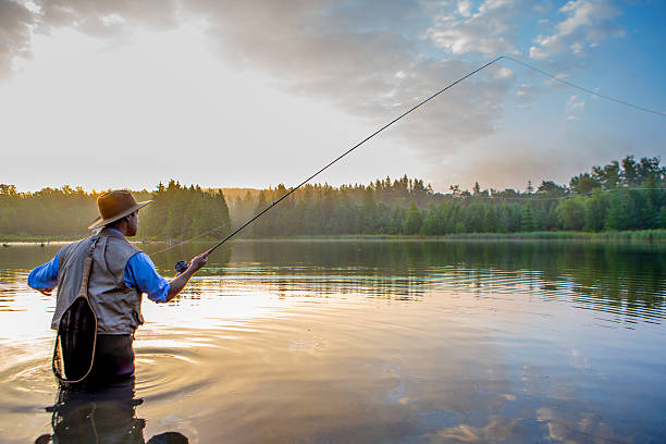 istock Young man flyfishing at sunrise 582309650