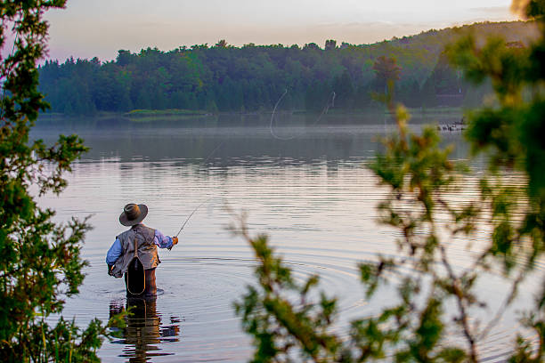 istock Young man flyfishing at sunrise 582310718
