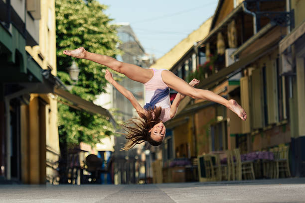 Beautiful little ballet dancer performs on the street