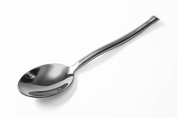 istock Stainless steel glossy metal kitchen spoon isolated 582310996