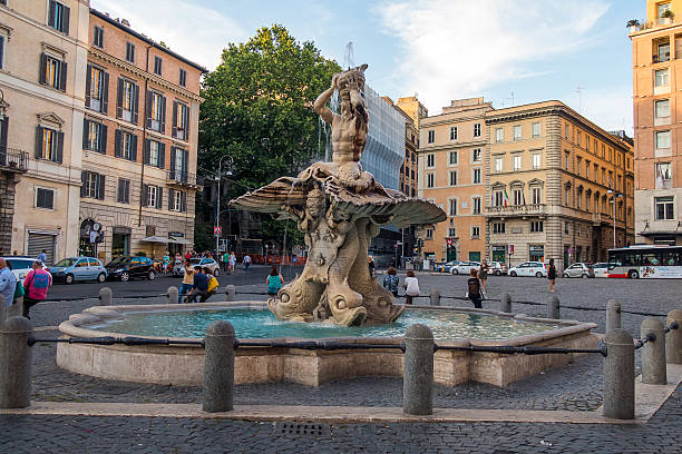 Rome, Italy Piazza Barberini tourists beside Triton Fountain. stock photo