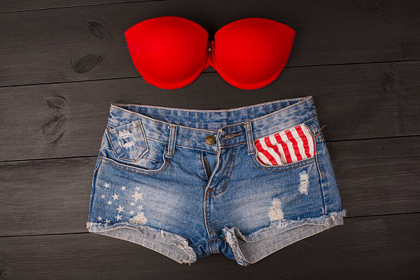 istock Woman's brassiere top and jeans shorts. 582311400