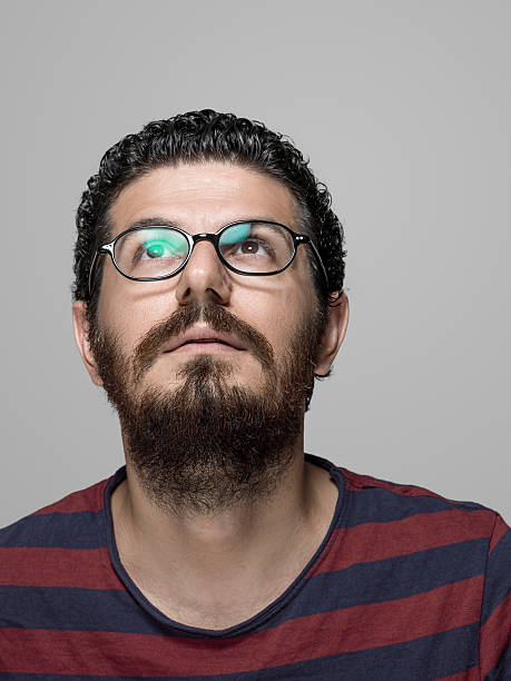 istock Portrait of adult man looking up and thinking 582311708