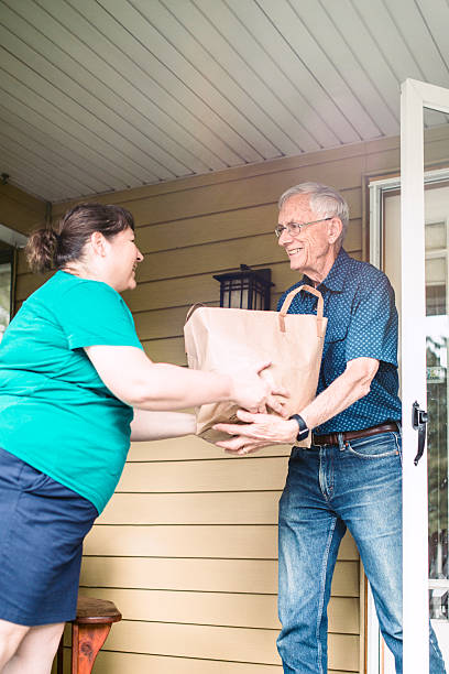 istock Delivering Groceries To Senior Man 582315554