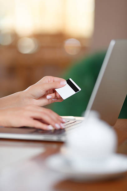 istock Hands holding credit card and using laptop 582315960