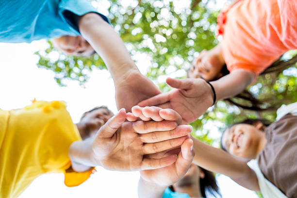 istock Kids have hands together in circle 582316548