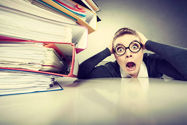 istock Accountant terrified of pils of binders. 582316936