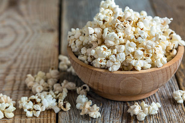 istock Popcorn in wooden bowl close up. 582316994
