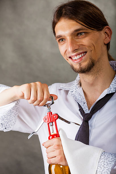 istock Waiter openning bottle of wine. 582317024