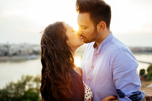 istock Romantic couple kissing during sunset 582317256